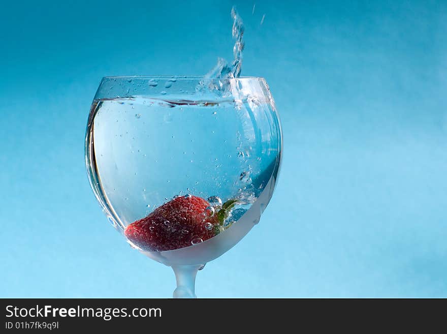 Strawberry thown into the gass of water. Strawberry thown into the gass of water