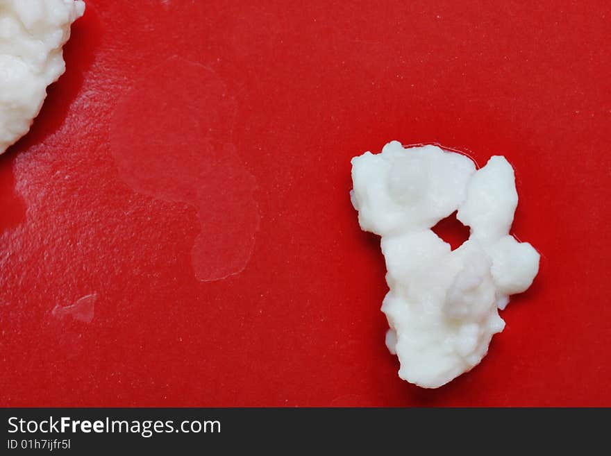 Cottage cheese on the red plate. Close-up. Narrow depth of field. Cottage cheese on the red plate. Close-up. Narrow depth of field.