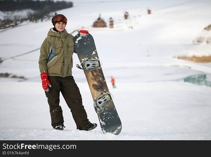 Young adult female snowboarder. winter