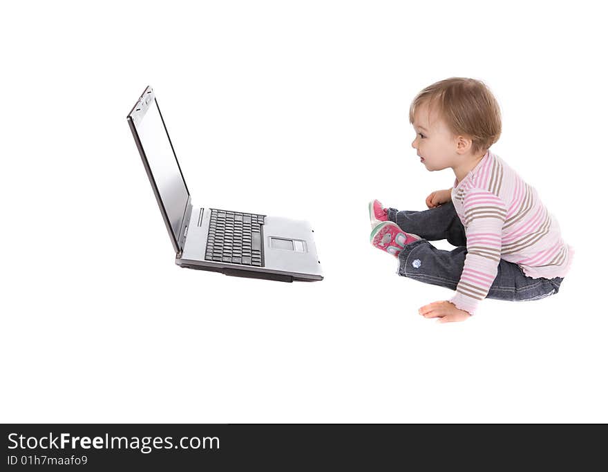 Sweet baby girl playing on laptop.over white background. Sweet baby girl playing on laptop.over white background