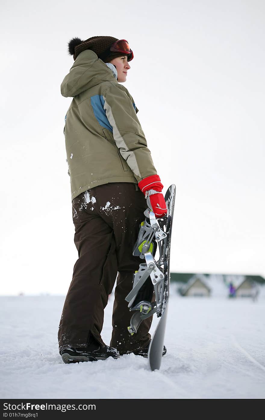 Young adult female snowboarder. winter