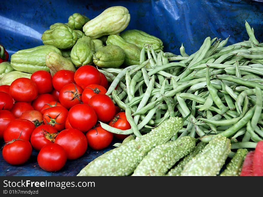 Fresh vegetables including tomatoes, beans, and squashes are displayed by a vendor at the Canton Road outdoor food market in Kowloon, Hong Kong  (Lee Snider Photo). Fresh vegetables including tomatoes, beans, and squashes are displayed by a vendor at the Canton Road outdoor food market in Kowloon, Hong Kong  (Lee Snider Photo)