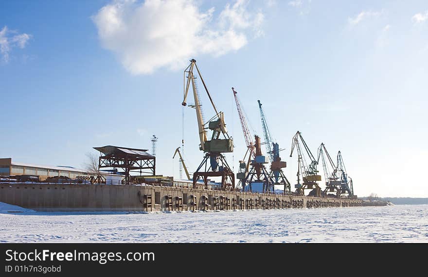 Port cranes in winter port. Port cranes in winter port