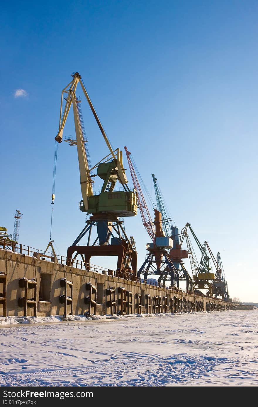 Port cranes in winter port. Port cranes in winter port