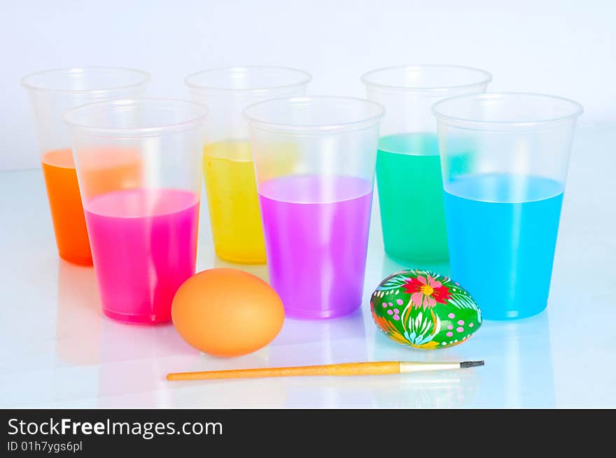 Two eggs lie near six glass with variegated water