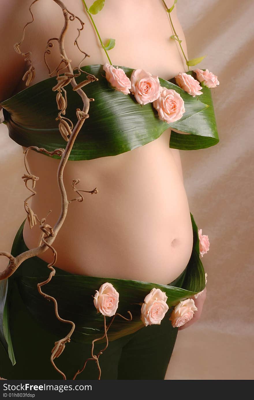 Pregnancy woman in the dressing made of a flowers. Pregnancy woman in the dressing made of a flowers