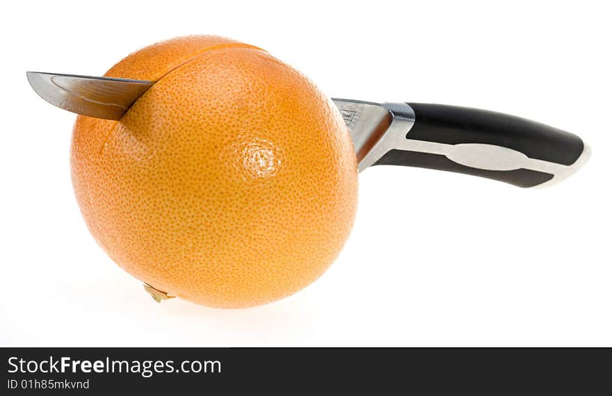 Grapefruit with knife