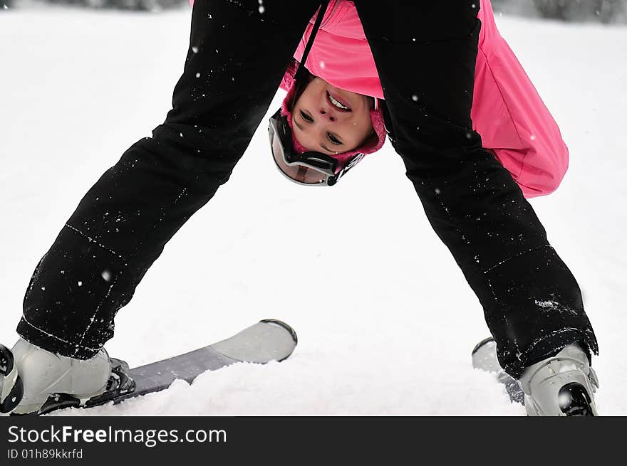 Girl on the mountain with skis himself in a strange perspective. Girl on the mountain with skis himself in a strange perspective