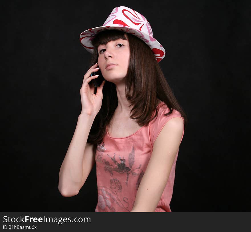 Girl talking by phone in studio