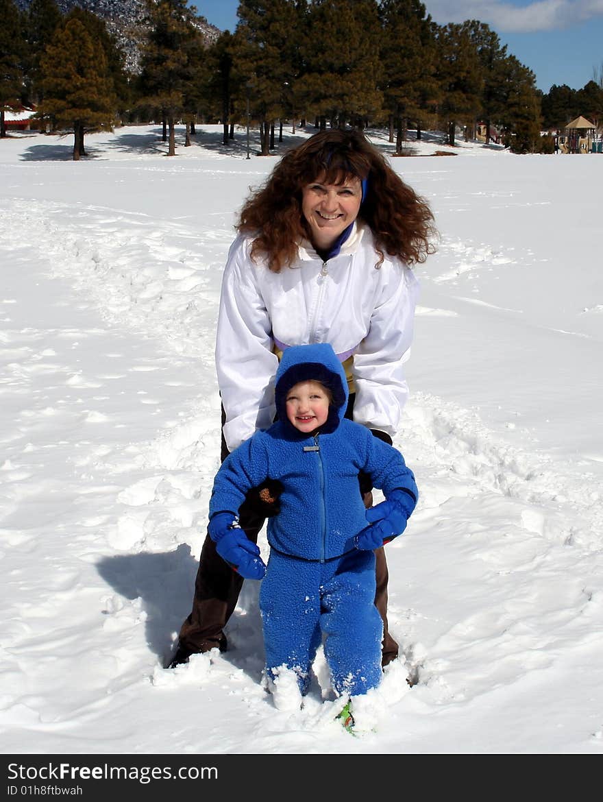 An Attractive Woman and a Little Girl in the Snow. An Attractive Woman and a Little Girl in the Snow