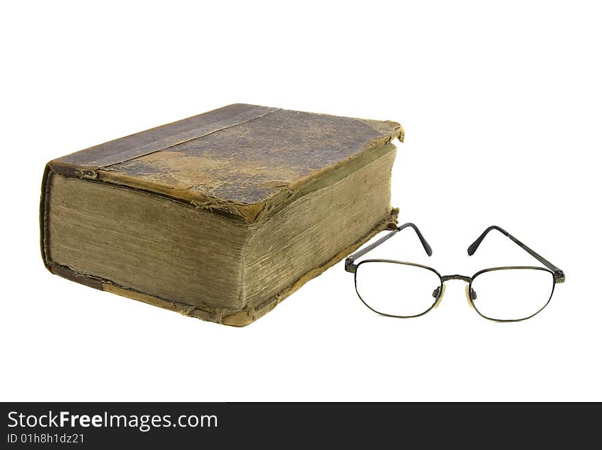 Glasses near very old bible on the white background