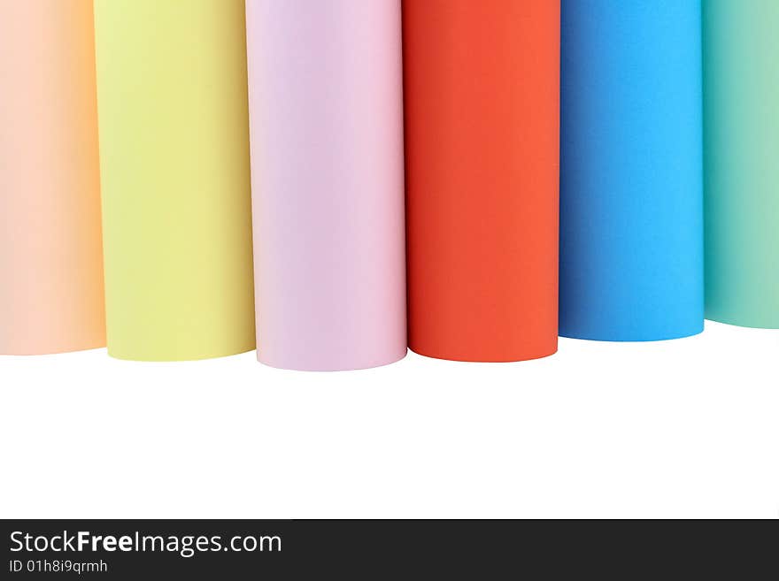 Various columns of color paper standing on white background