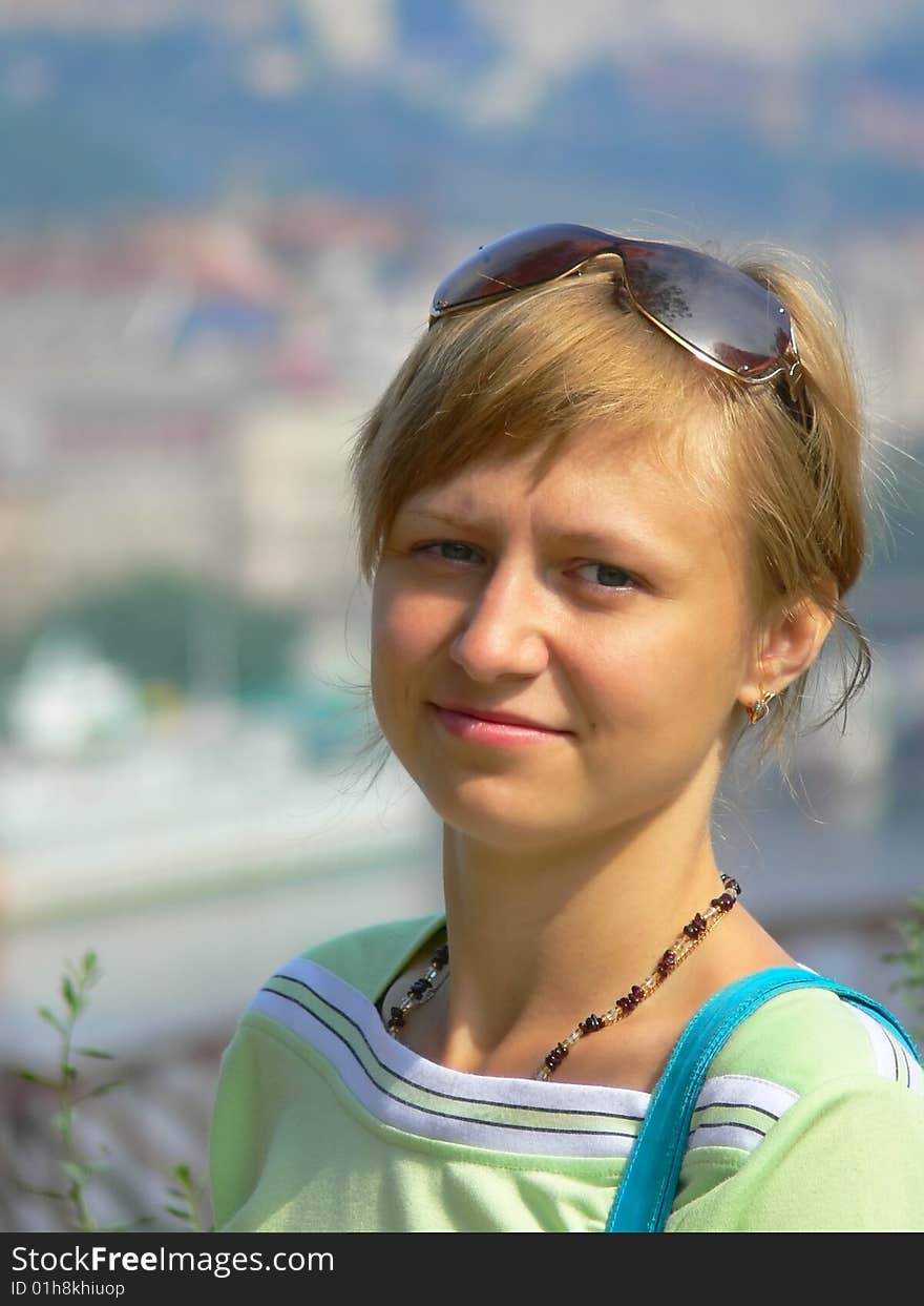 A portrait of beautiful girl is in a green sport shirt