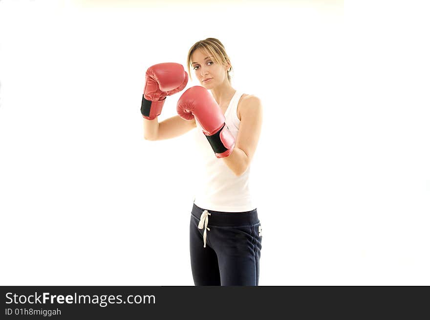 Young kickboxer woman training, isolated