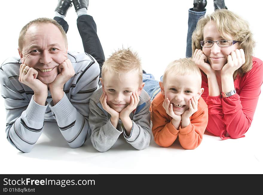 Family of four people lying on the floor. Family of four people lying on the floor