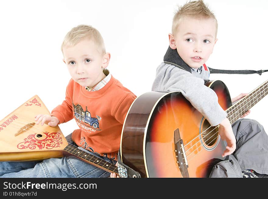 Brothers playing on stringed musical instruments. Brothers playing on stringed musical instruments