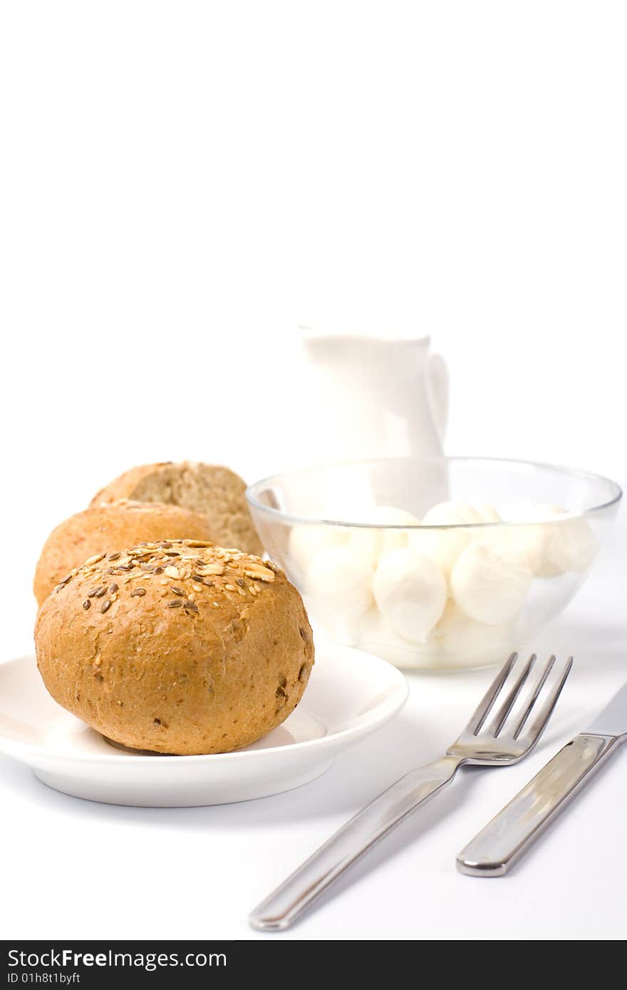 Bread, milk and mozzarella closeup on white