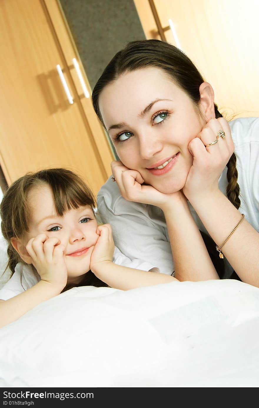 Mother And Daughter On The Bed