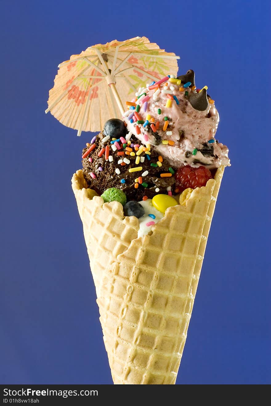 Close up shot of nice ice cream with umbrella on blue background. Close up shot of nice ice cream with umbrella on blue background