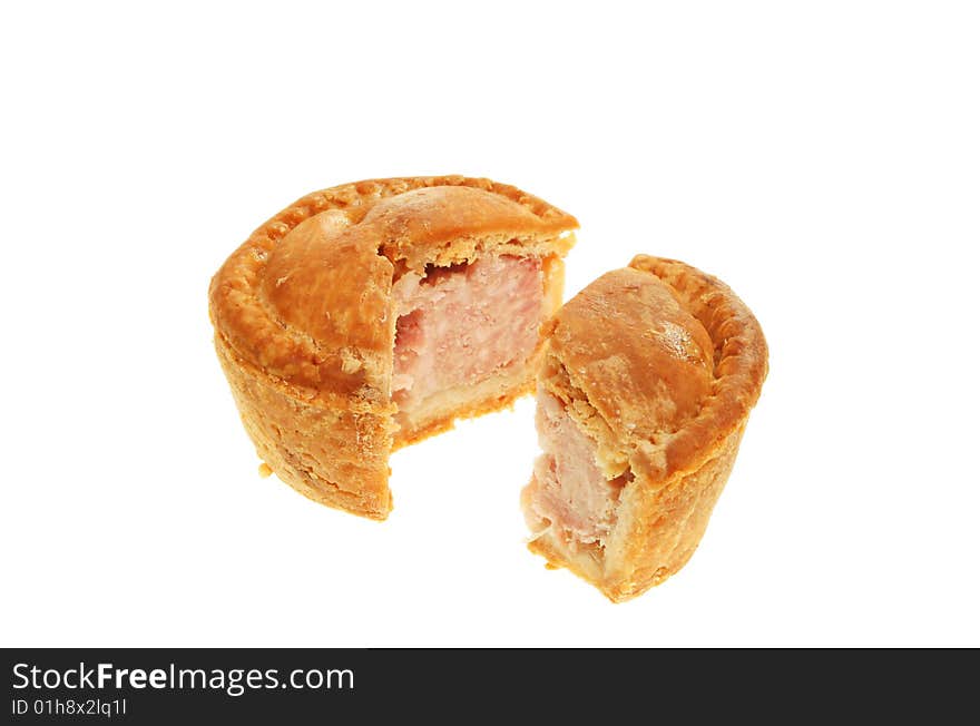 Cut pork pie isolated on white