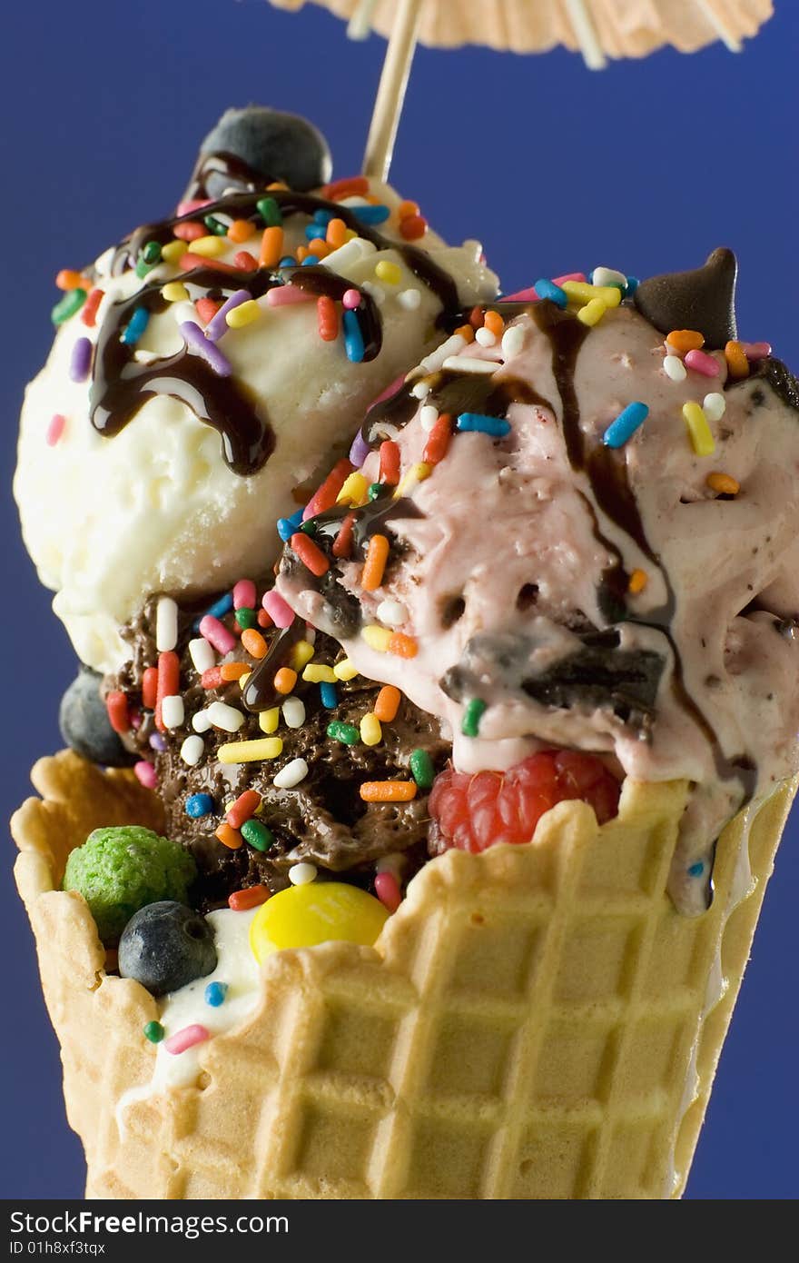 Close up shot of nice ice cream with chocolate on blue background