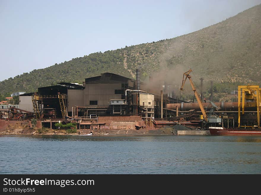 An industrial complex sitting on a lake in Greece.