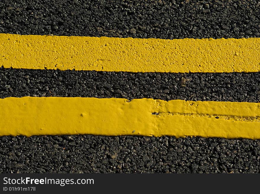 Close up of double yellow lines on the tarmac