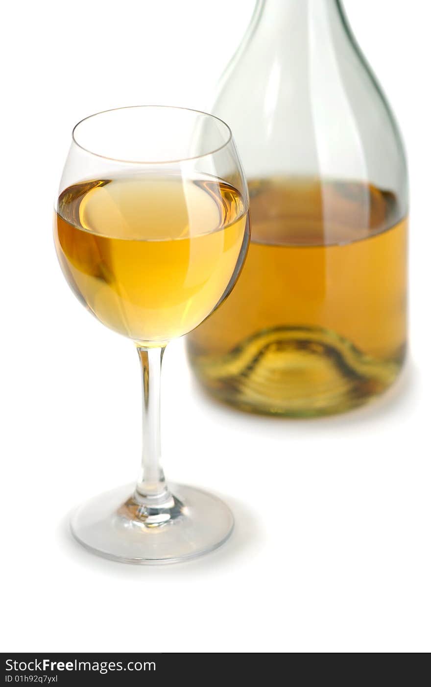 Glass and bottle of excellent white wine on a white background