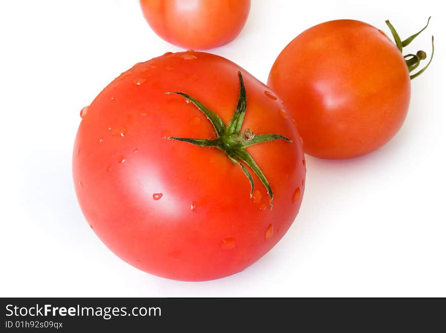 Three tomatoes on a white background