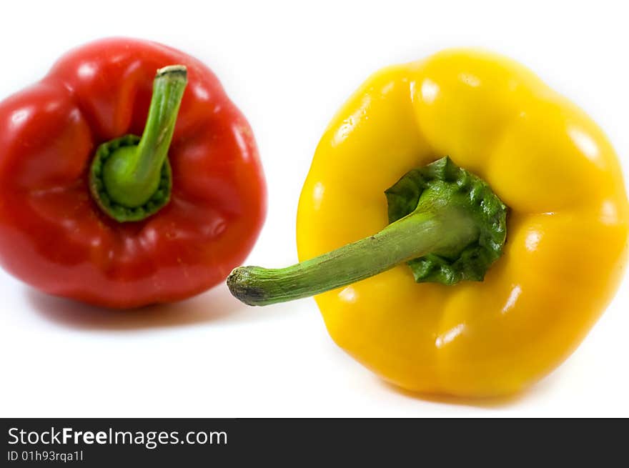 Red and yellow pepper over white. Red and yellow pepper over white