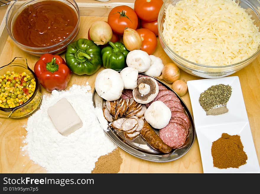 Top view at wood table full of pizza ingredients. Top view at wood table full of pizza ingredients