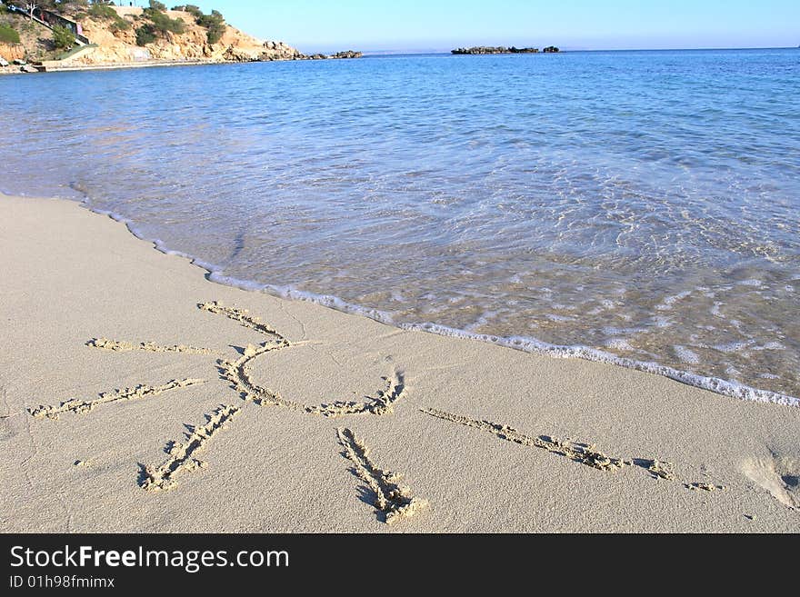 Sun in the sand on tropical beach with clear blue sea. Sun in the sand on tropical beach with clear blue sea