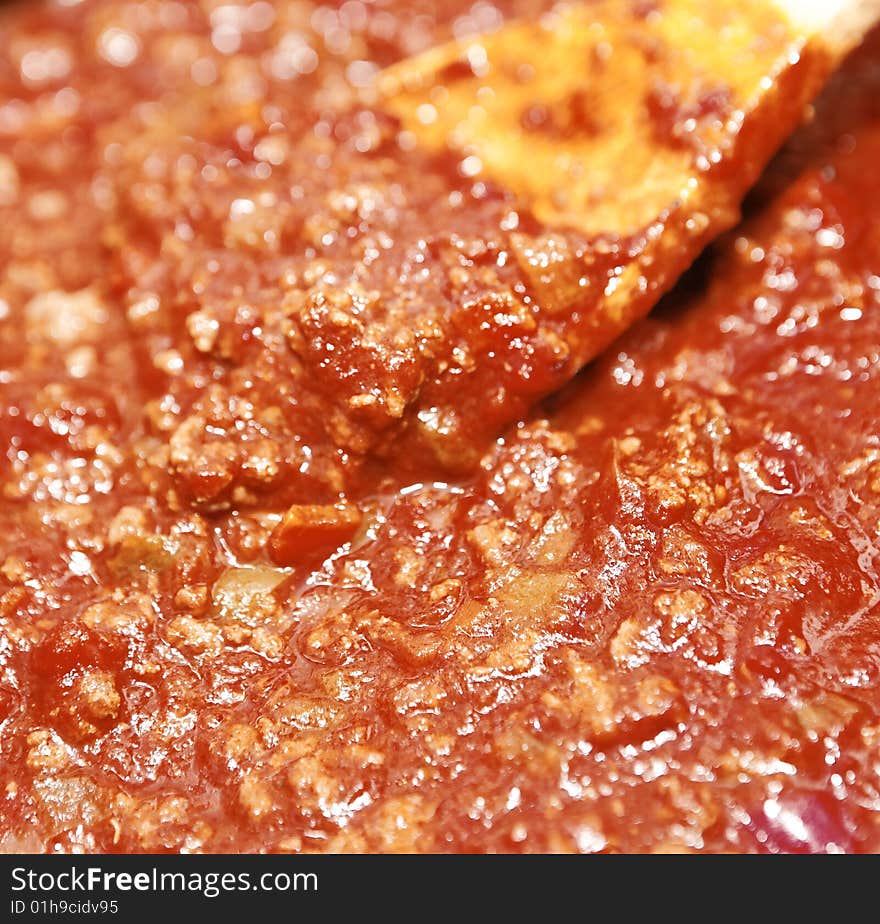 Close up spaghetti sauce with wood utensil. Close up spaghetti sauce with wood utensil