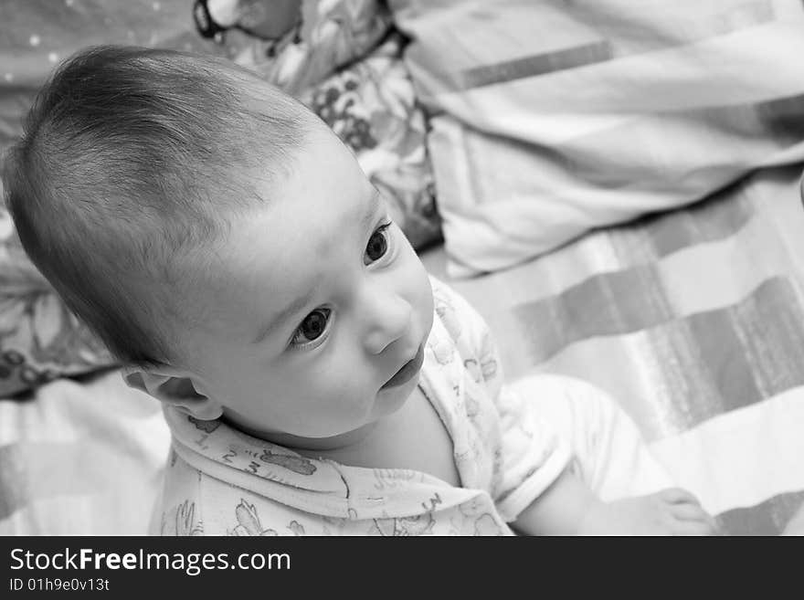 Child Sits On A Bed