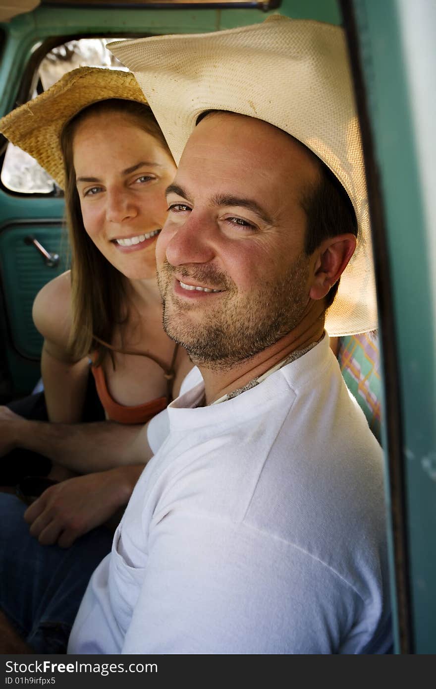 Cowboy and woman in pickup truck