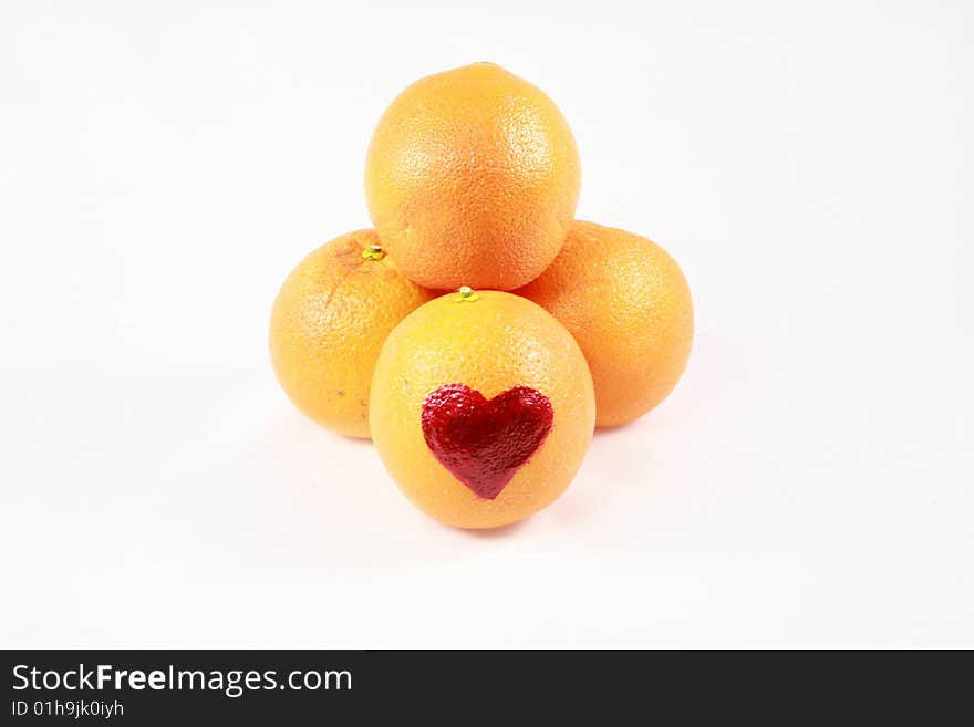 An array of oranges with a heart on one. An array of oranges with a heart on one