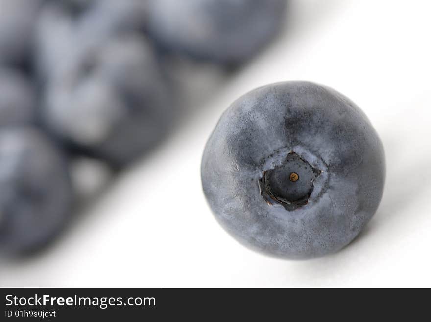 Extreme macro photo of a single blueberry with blurry blueberries far in the background. Extreme macro photo of a single blueberry with blurry blueberries far in the background.