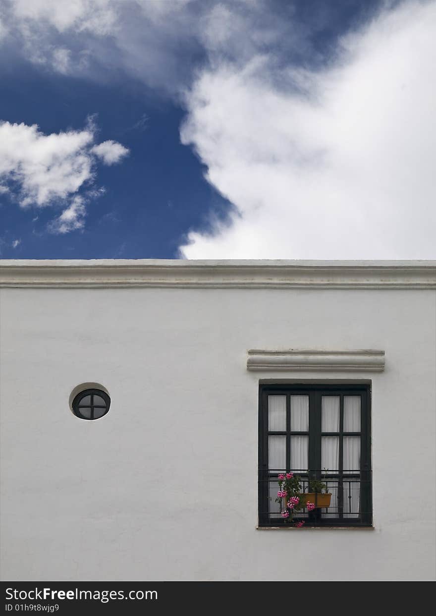 Facade of a white simple mediterranean house. Facade of a white simple mediterranean house.