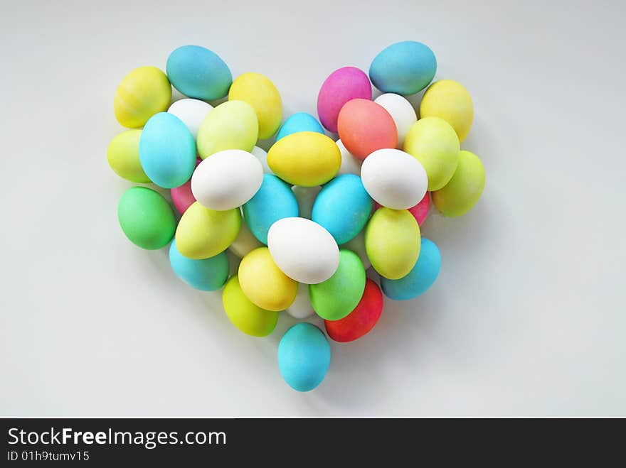 Colored easter eggs stacked into a heart. Colored easter eggs stacked into a heart