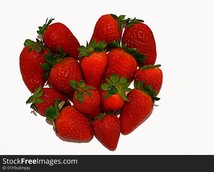 Symbol heart made of strawberry on a white background