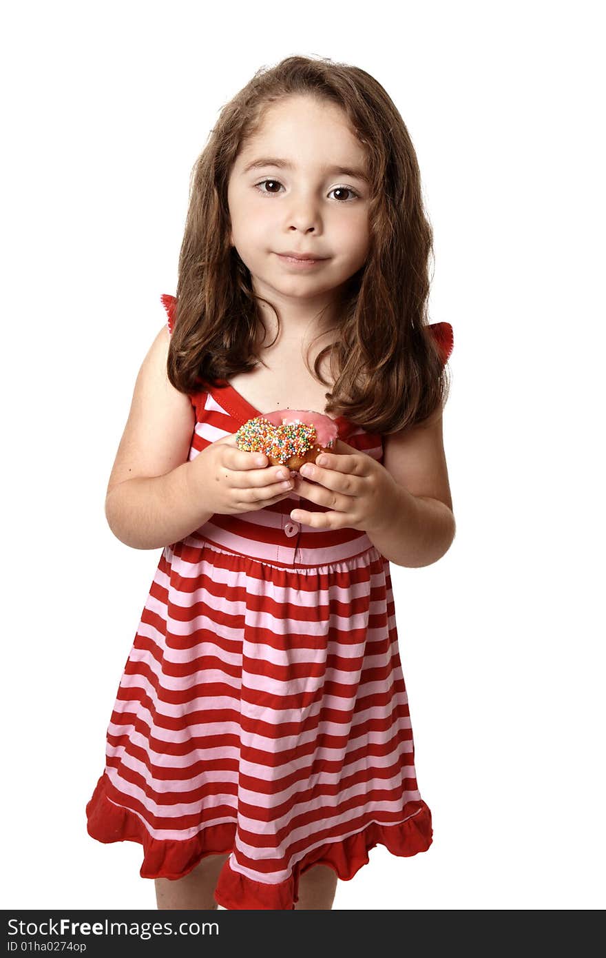 Young child holding a pink iced doughnet.   She is wearing a pink and red striped dress with little pink  heart buttons. Young child holding a pink iced doughnet.   She is wearing a pink and red striped dress with little pink  heart buttons.