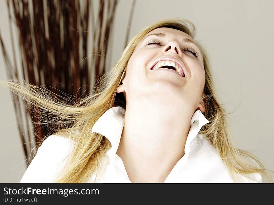 Young blond model smiling with head layed back