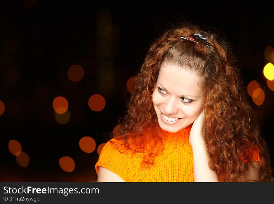 The girl with curly hair against evening sparks. The girl with curly hair against evening sparks