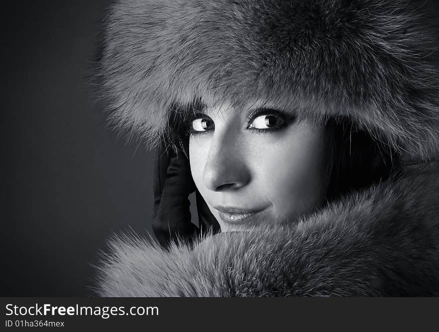 Portrait of young beautiful brunette on a darck background