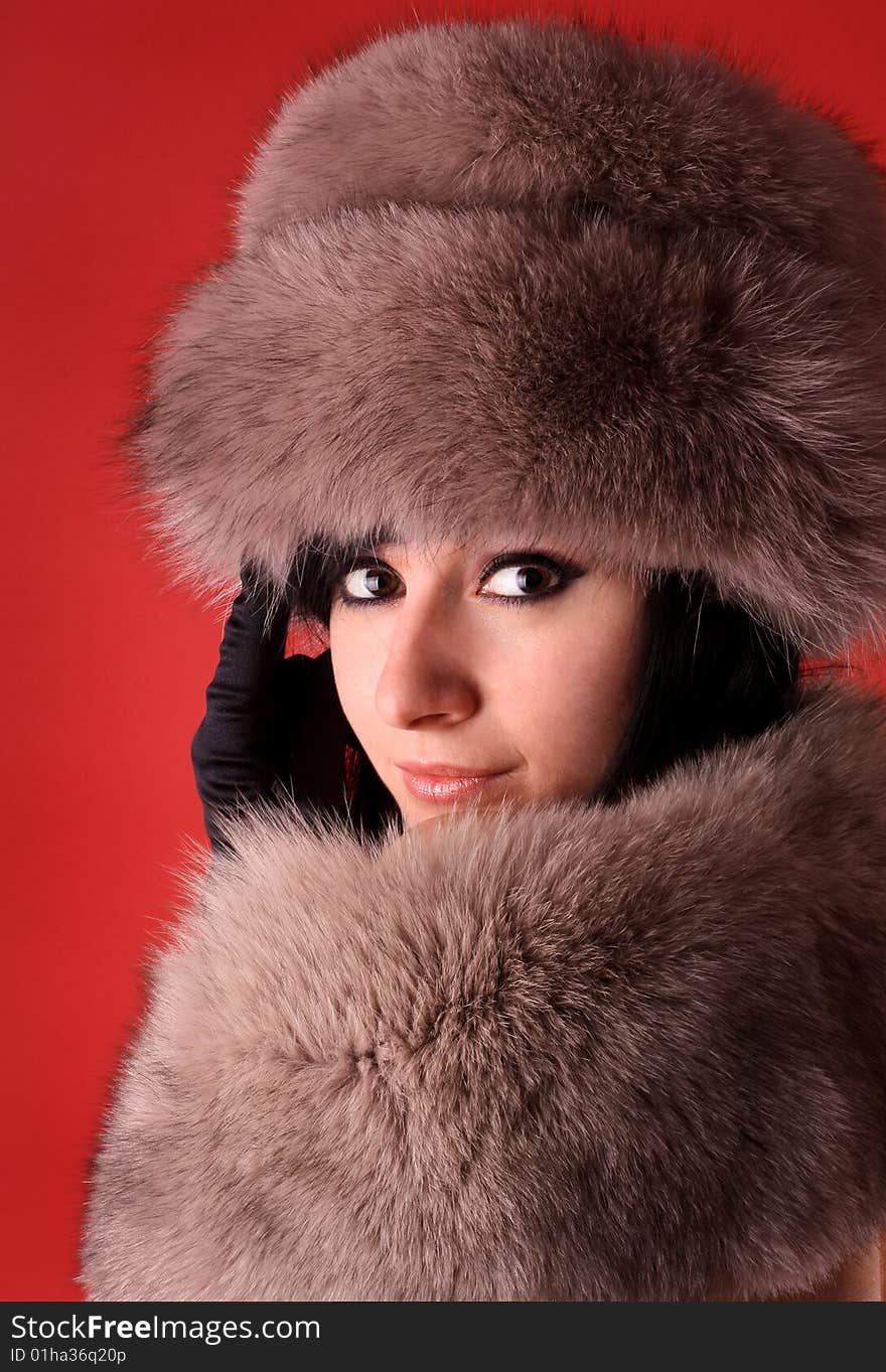 Portrait of young beautiful brunette on a red background