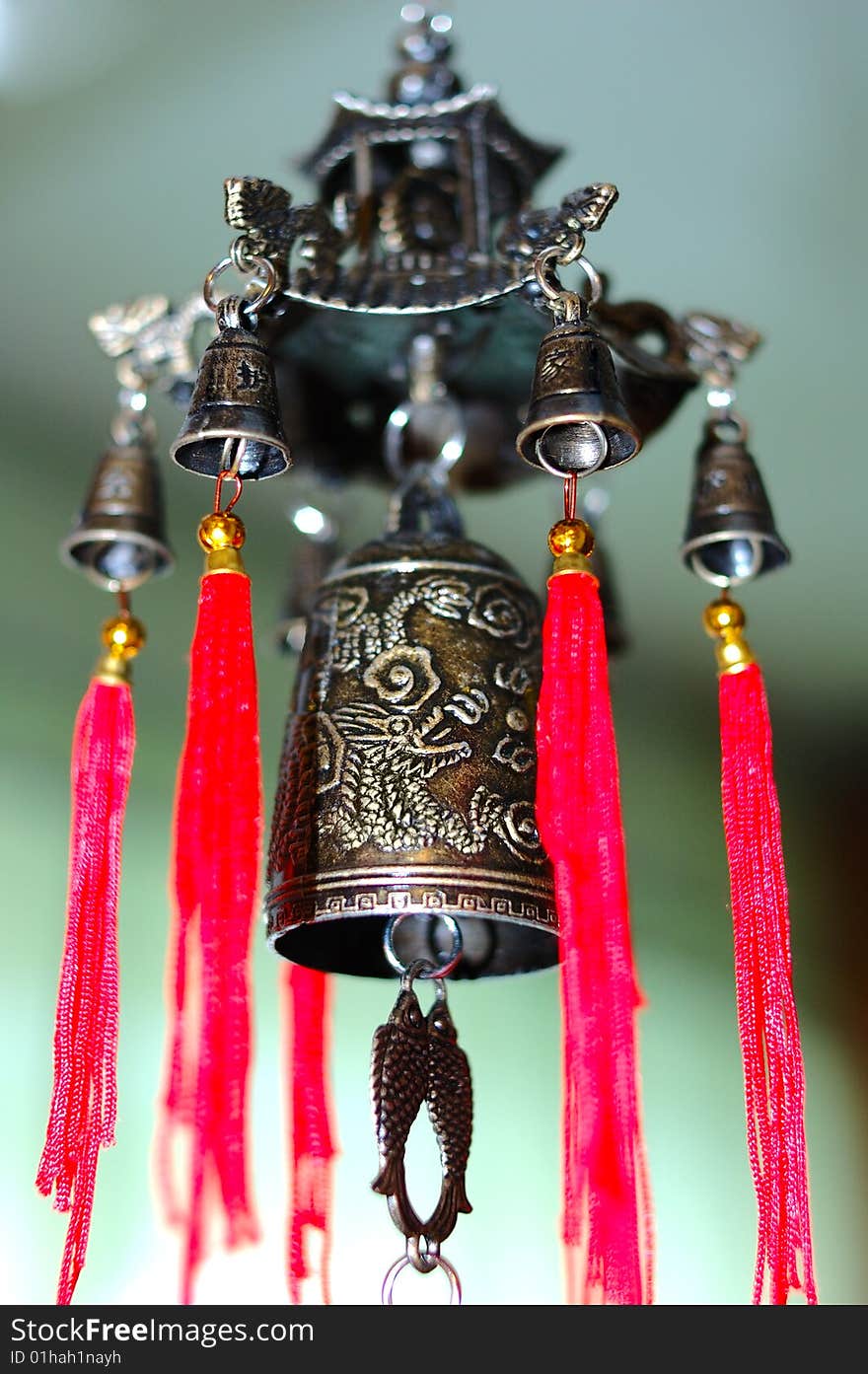 Old chinese bronze bell with dragons and hieroglyphs - on defocused (blurred) background. Old chinese bronze bell with dragons and hieroglyphs - on defocused (blurred) background.