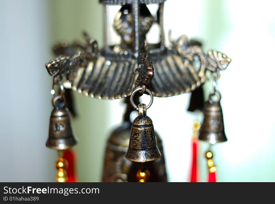 Old chinese bronze bell with dragons and hieroglyphs - on defocused (blurred) background. Old chinese bronze bell with dragons and hieroglyphs - on defocused (blurred) background.