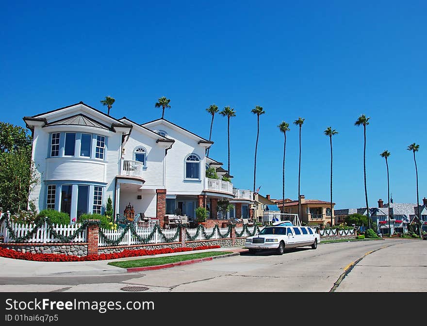 A big house with a limousine parked outside. A big house with a limousine parked outside