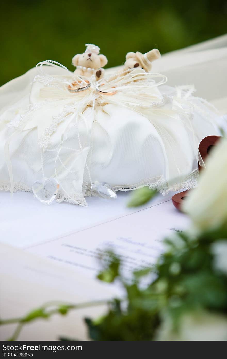 Wedding rings on the ring textile holder with two teddy bears. Wedding rings on the ring textile holder with two teddy bears