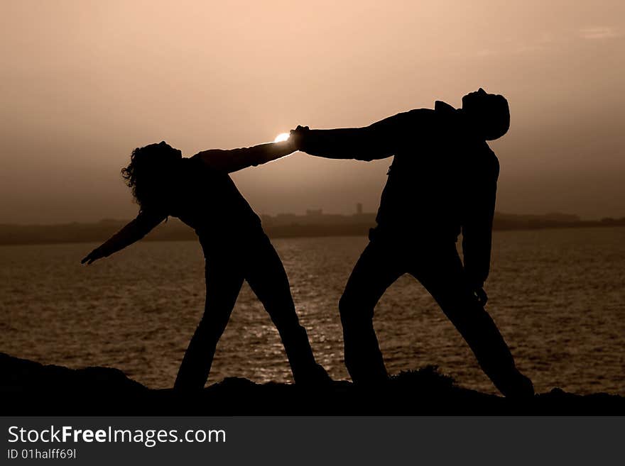 Couple at sunset with a city in the background